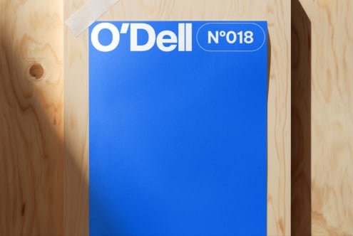 Bright blue card with O'Dell branding in white type, numbered 018, sitting on light wood surface