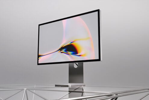 Desktop monitor mockup displaying vibrant chromatic aberration artwork in sleek black frame