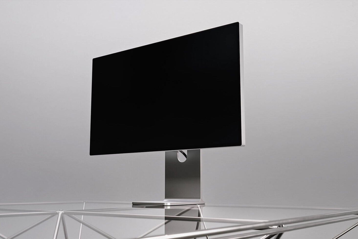 Monitor mockup with black screen on metal stand against gray background