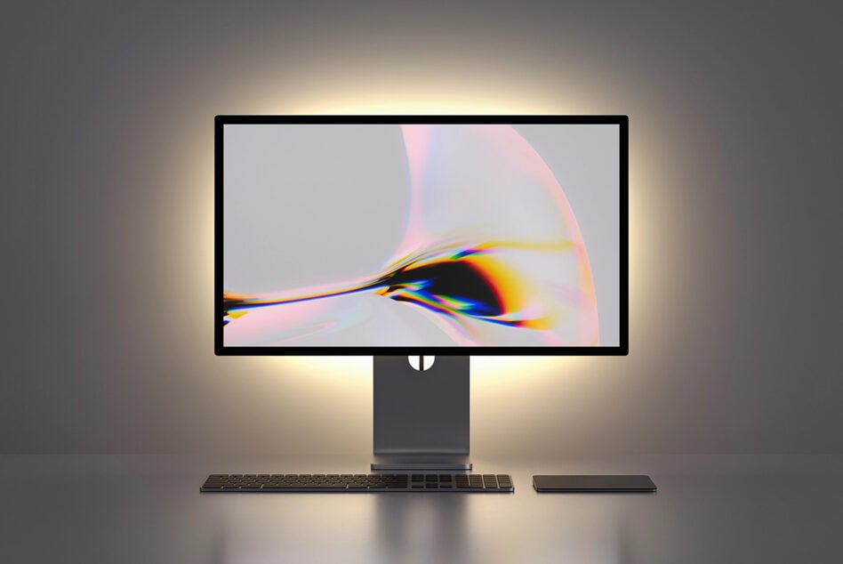 Desktop monitor mockup displaying vibrant chromatic aberration artwork with keyboard setup