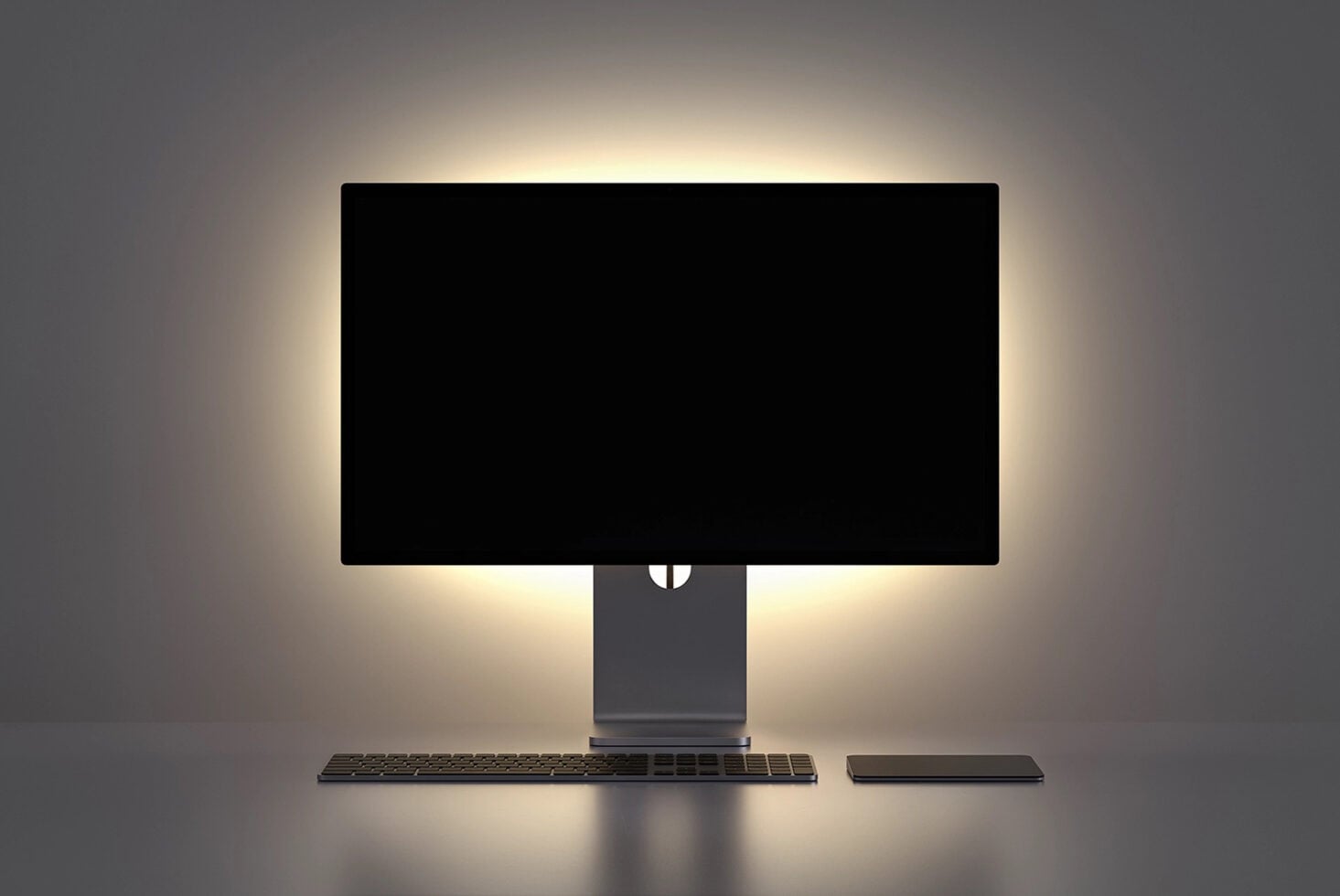 Modern desktop setup with monitor, keyboard, trackpad on soft gray backdrop