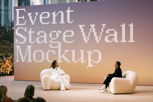 Event stage wall mockup with two speakers sitting in cream chairs, pixel font text on gradient backdrop