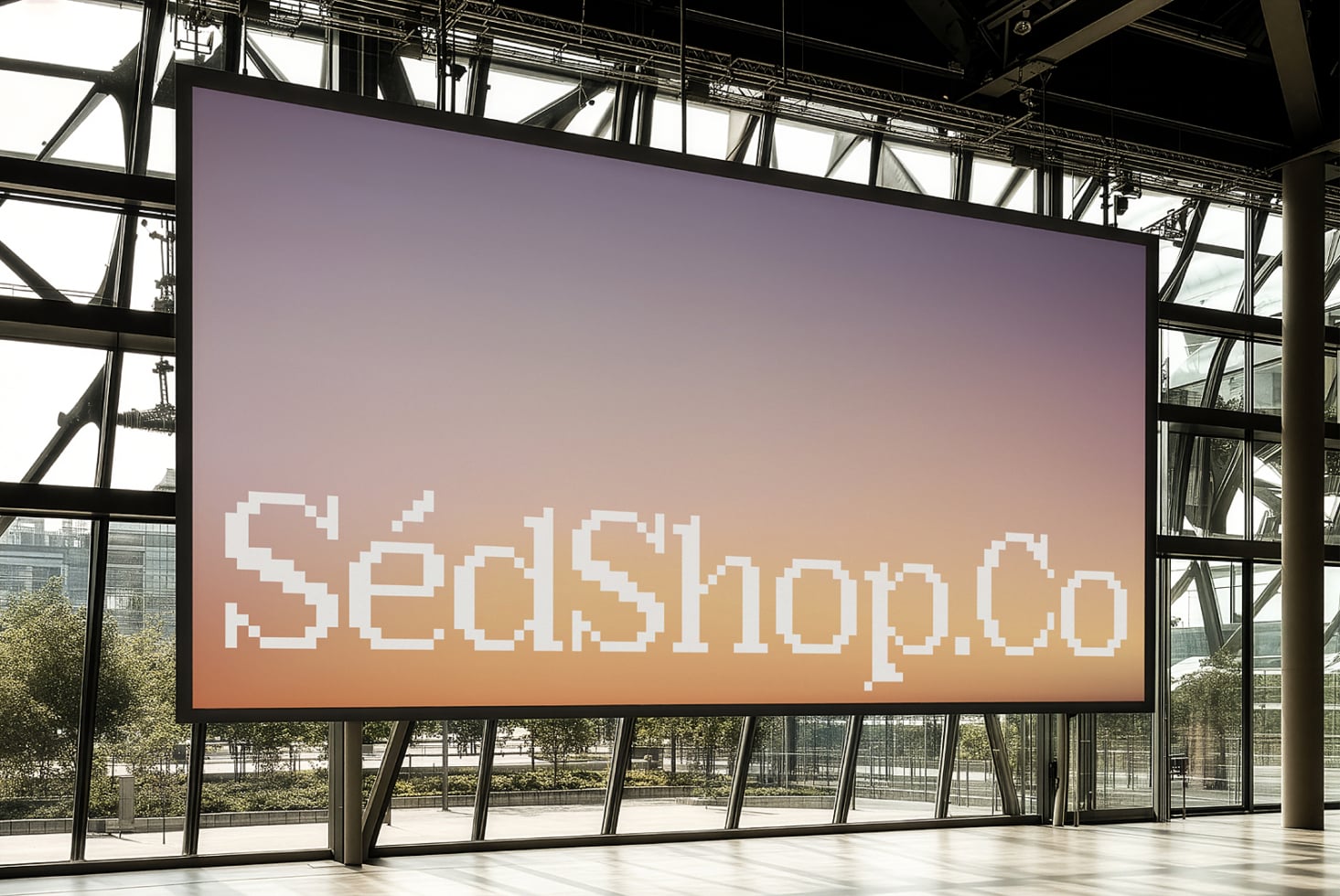 Large indoor LED screen displaying pixelated white text on gradient purple to peach background in modern venue