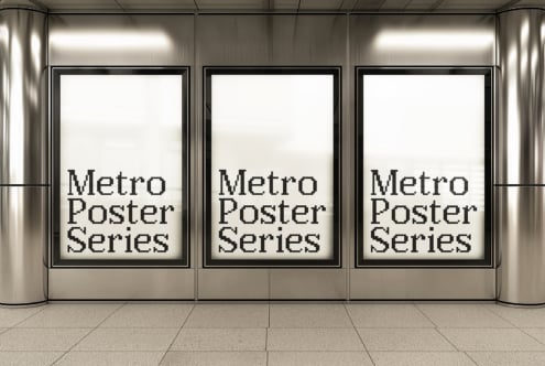 Three framed posters in a sleek modern storefront with metal walls