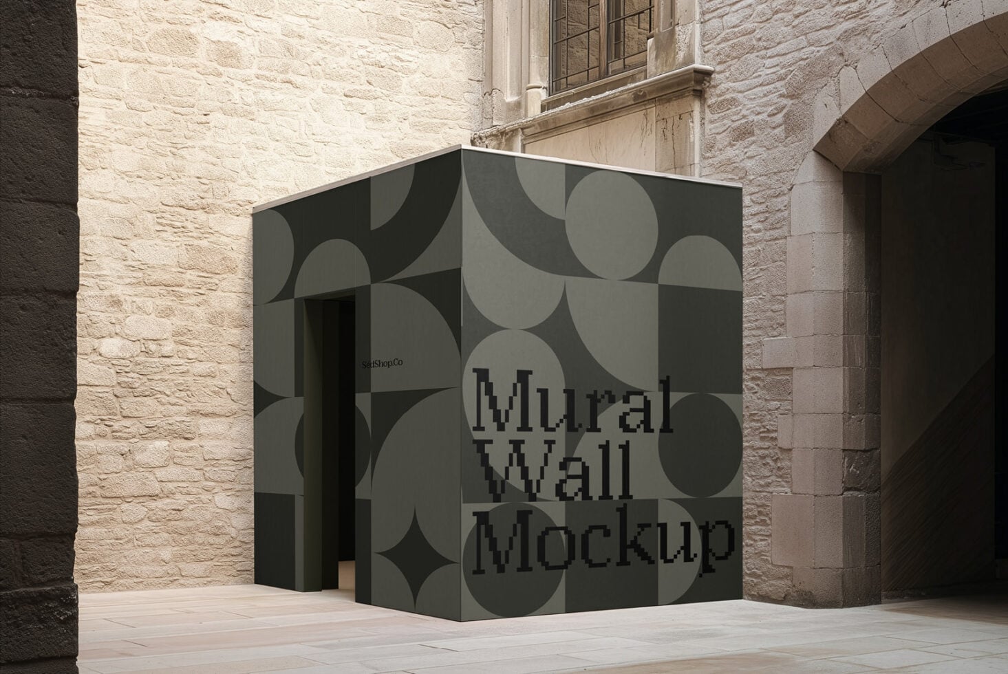 Geometric mural wall mockup on corner kiosk in stone courtyard with abstract circular pattern