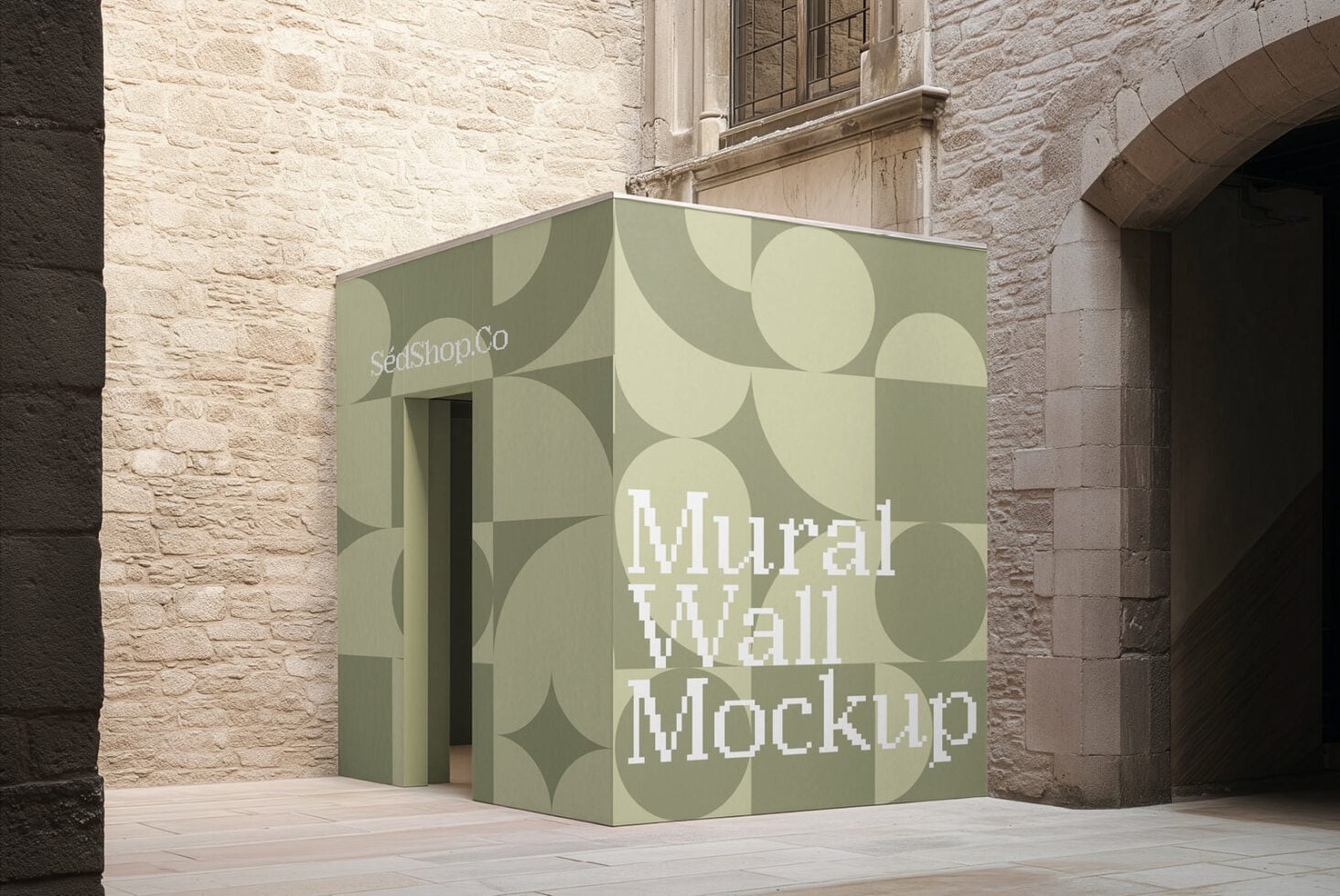 Sage green kiosk with geometric shapes displayed in historic stone courtyard setting