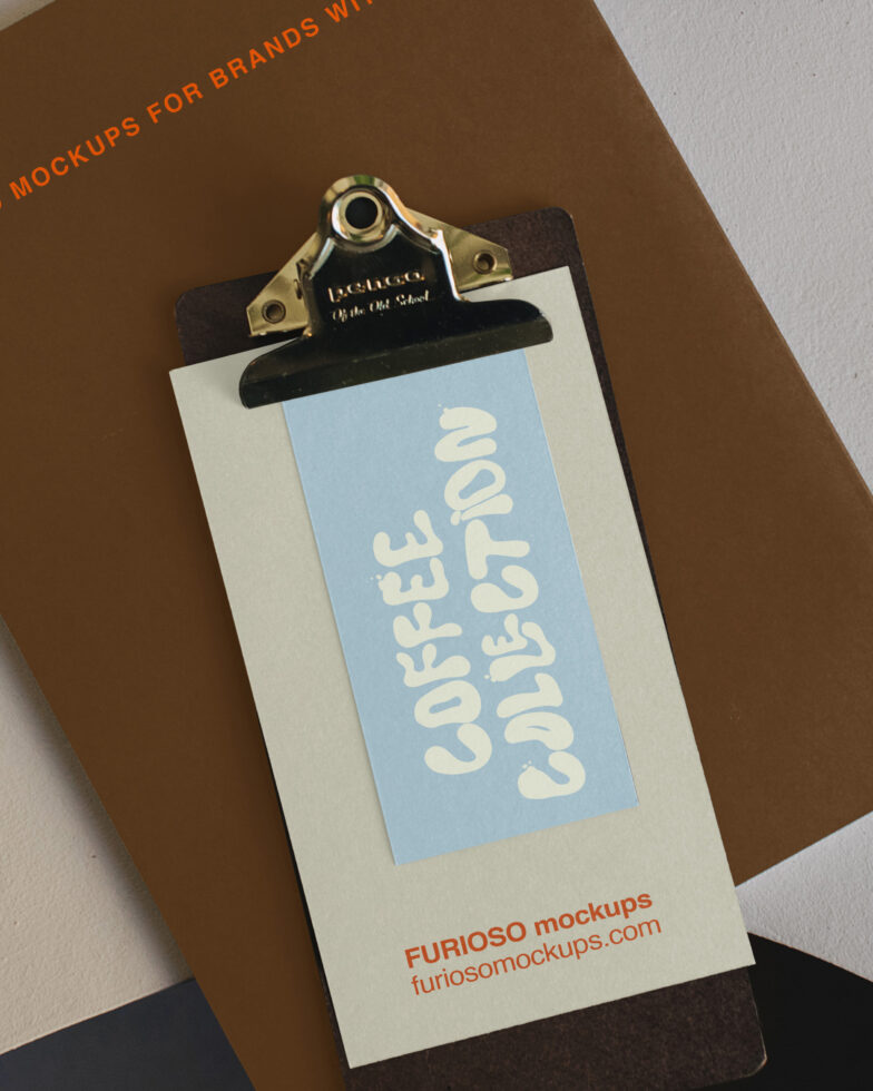 Vintage clipboard mockup with blue label showing cream colored text on kraft paper background