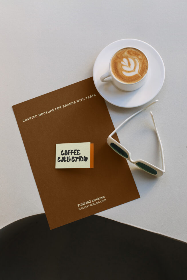 Flat lay of brown brochure with latte cup, sunglasses, showing coffee brand mockup setup