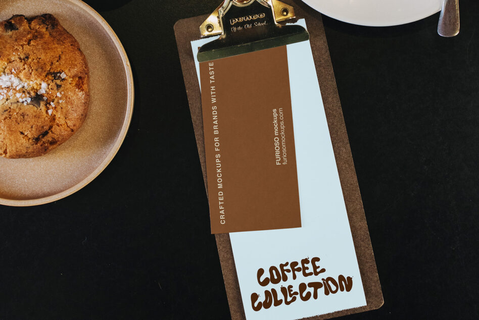 Clipboard mockup with brown paper card showing coffee branding alongside fresh baked cookies on dark surface