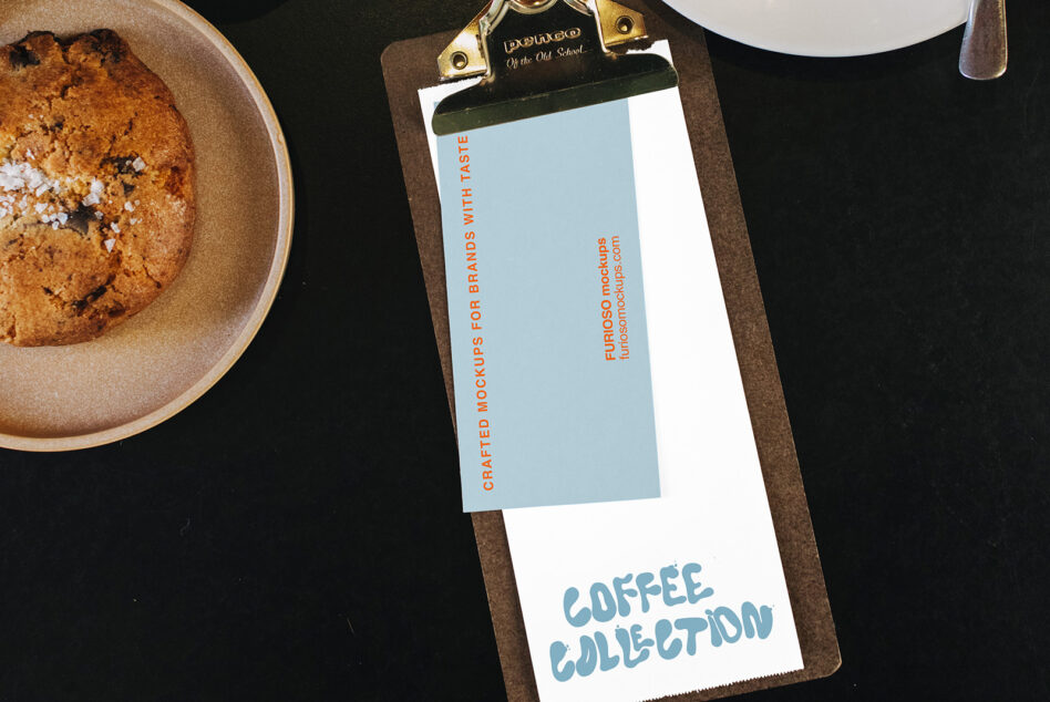 Clipboard mockup with pastry, coffee cup, styled on dark surface with branded stationery