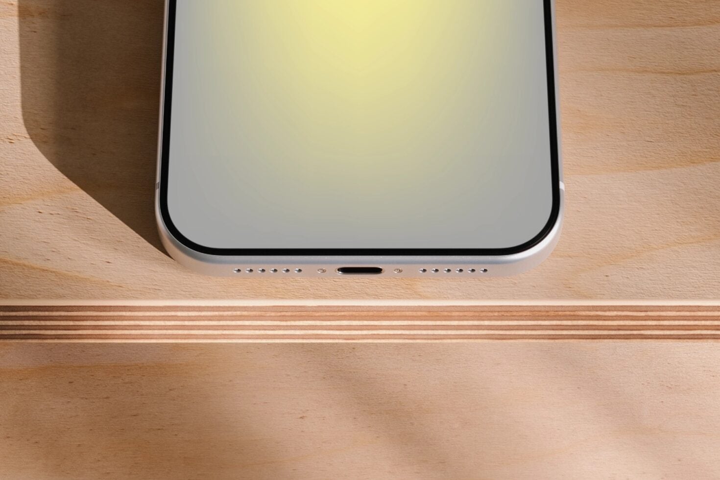Silver iPhone mockup flat lay on natural wood surface with soft shadows
