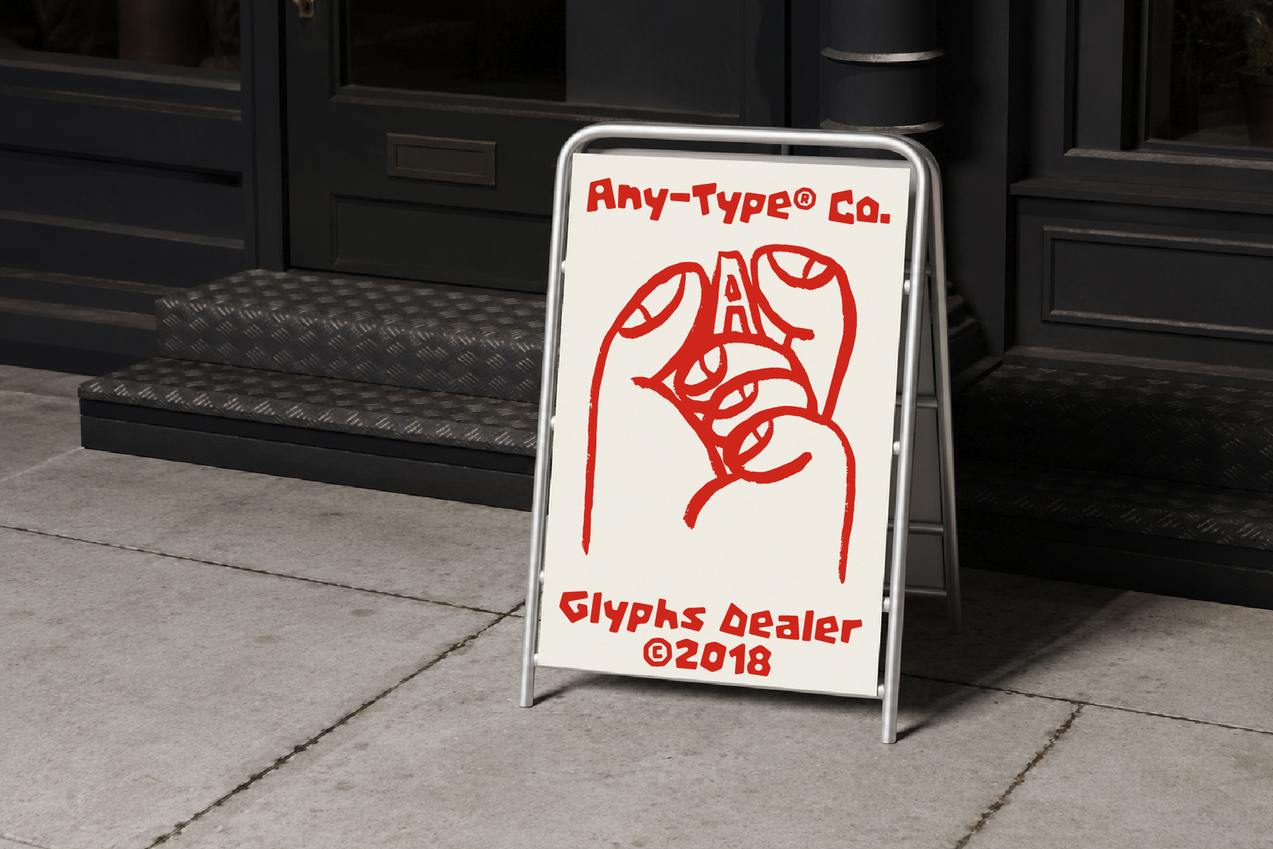 Sidewalk A-frame sign with red hand-drawn lettering for Any-Type Co. glyphs dealer storefront mockup