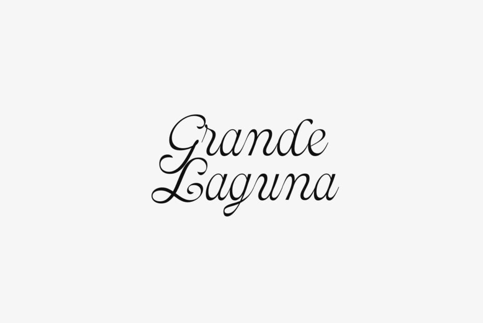 Grande Laguna elegant script font with flowing cursive letterforms on cream background