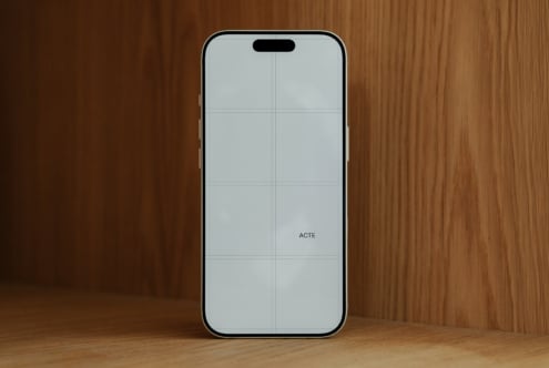 iPhone 14 Pro mockup on wooden background with blank screen ready for designs