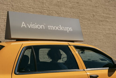 Taxi roof sign mockup with gray panel on yellow cab against brick wall
