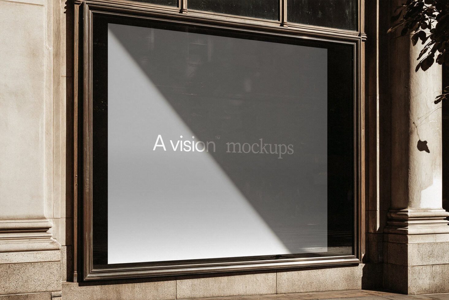 Storefront window display with sunlight casting diagonal shadows across blank white space in black frame