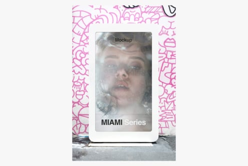 Phone mockup with bright pink graffiti border on urban street backdrop