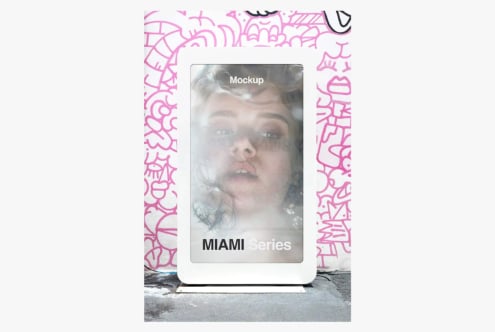 Street billboard mockup with hot pink graffiti frame showing portrait photo on display