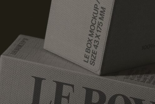 Stacked product boxes with embossed text on textured paper stock, close-up angle