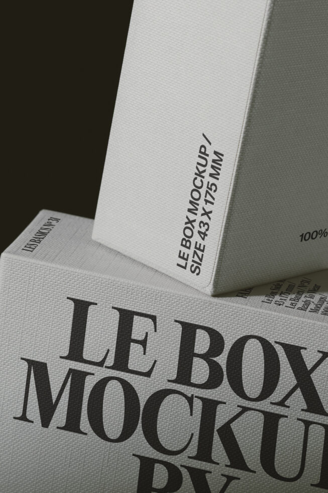 Stacked white boxes with serif typography showing product labels, overhead shot