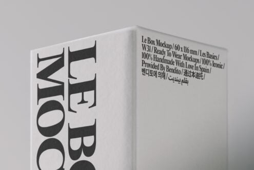 Minimalist white box mockup with bold black typography, angled view showing front with multilingual text