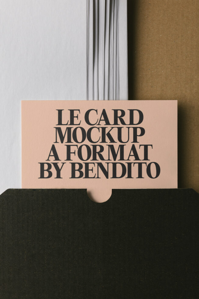 Peach business card mockup with bold serif type nestled in black paper stack