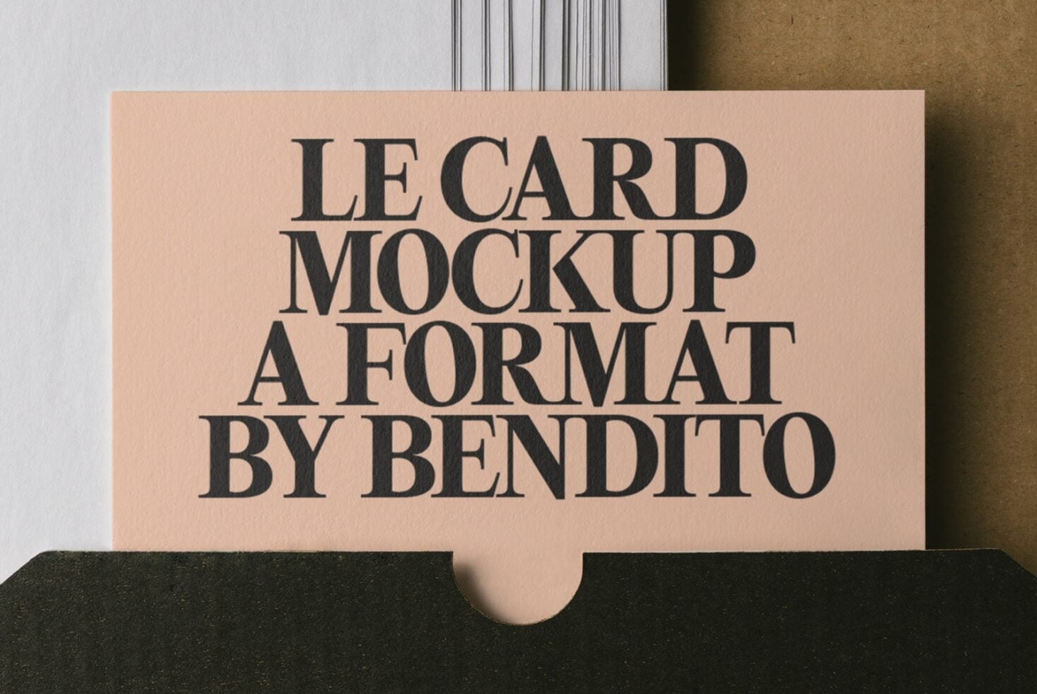 Beige lecard mockup in black envelope with serif typography on textured background