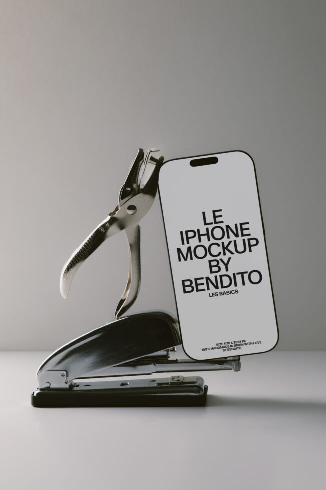 iPhone mockup leaning against vintage stapler with editable screen display