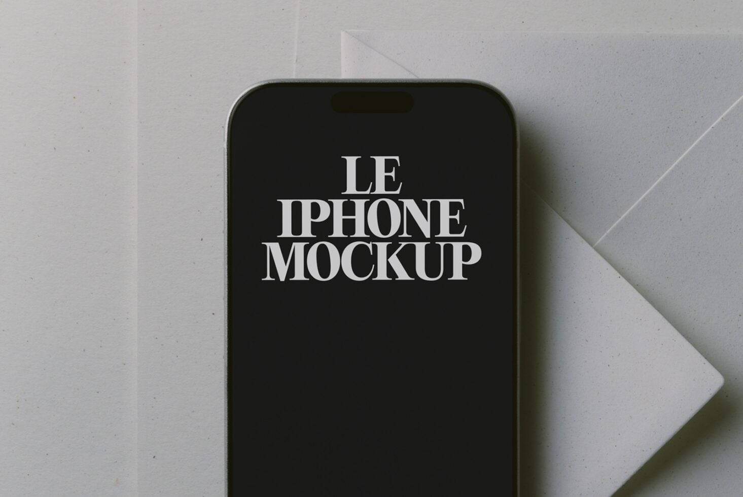 Styled iPhone mockup with serif text on black screen, shot flat lay on white paper background