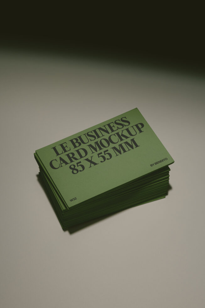 Stacked green business cards in 85x55mm size with angled top card showing typography layout