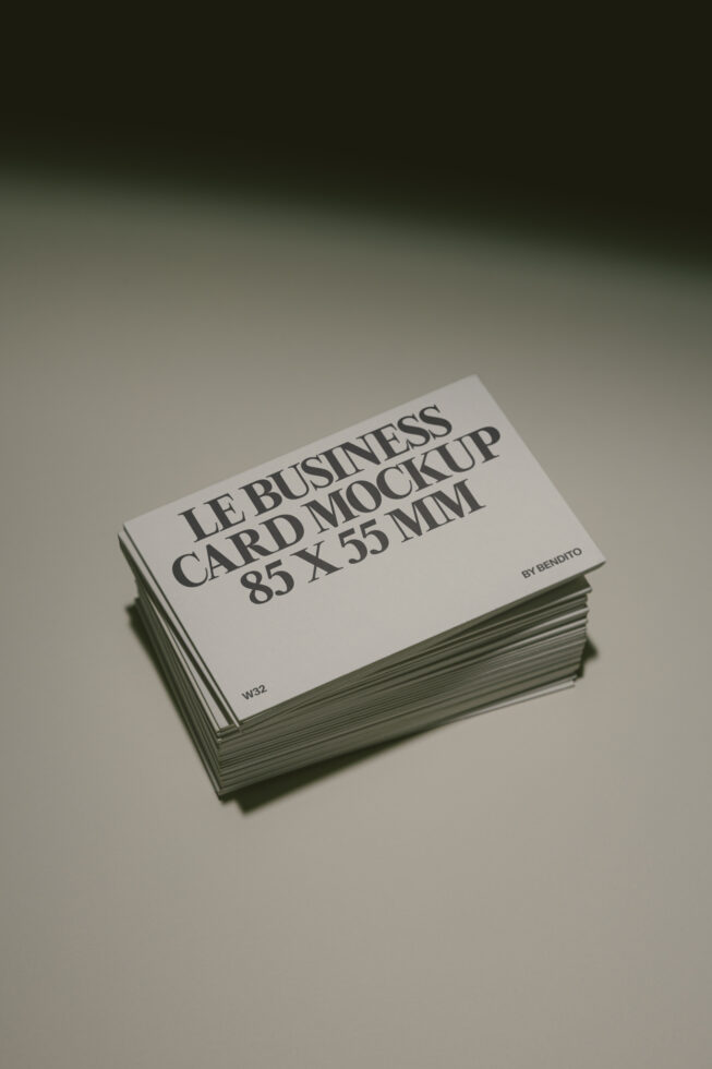 Stack of business cards with serif typography on cream stock, angled view