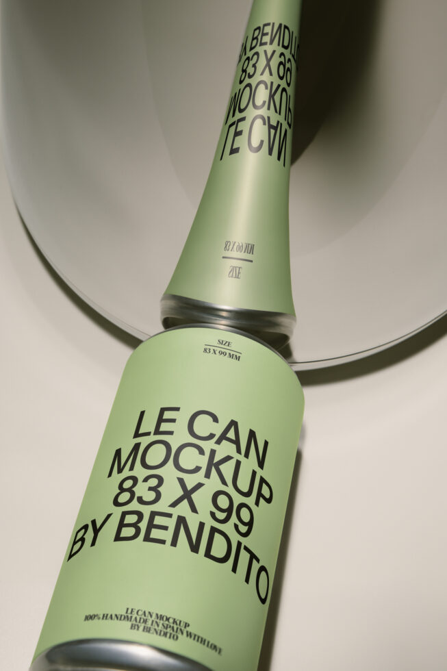 Overhead shot of two green cans with bold typography labels casting shadows on white surface