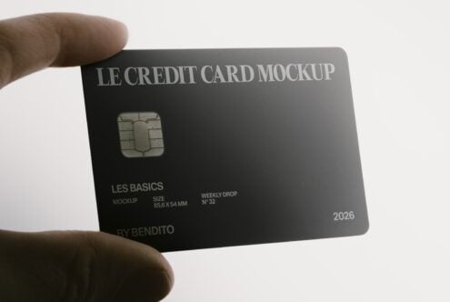 Hand holding sleek black credit card mockup with chip, expiry date, branding text visible