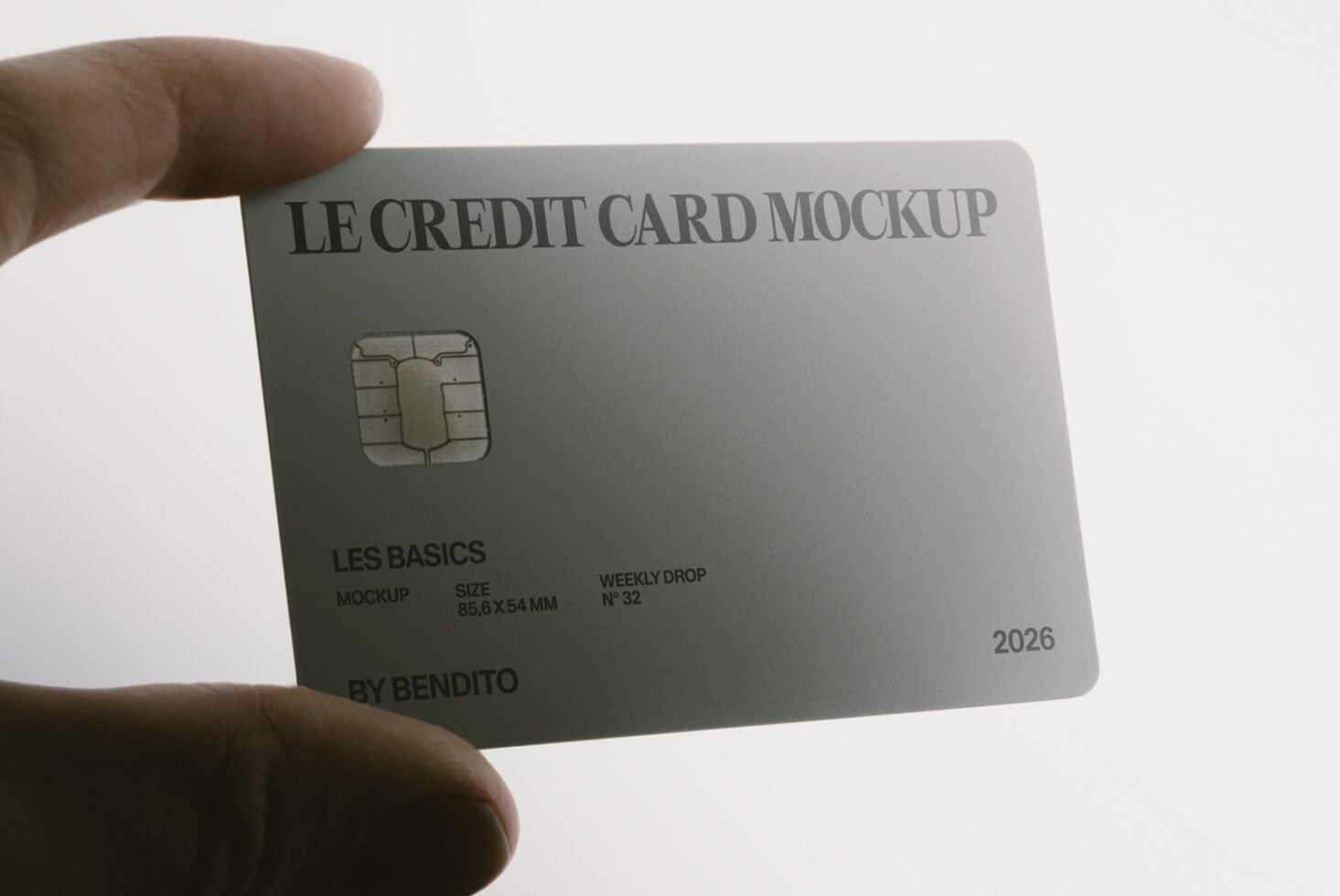 Hand holding silver credit card mockup with chip, text, expiration date
