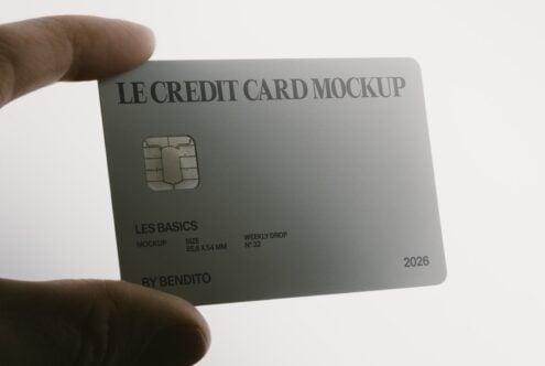 Hand holding silver credit card mockup with chip, text, expiration date
