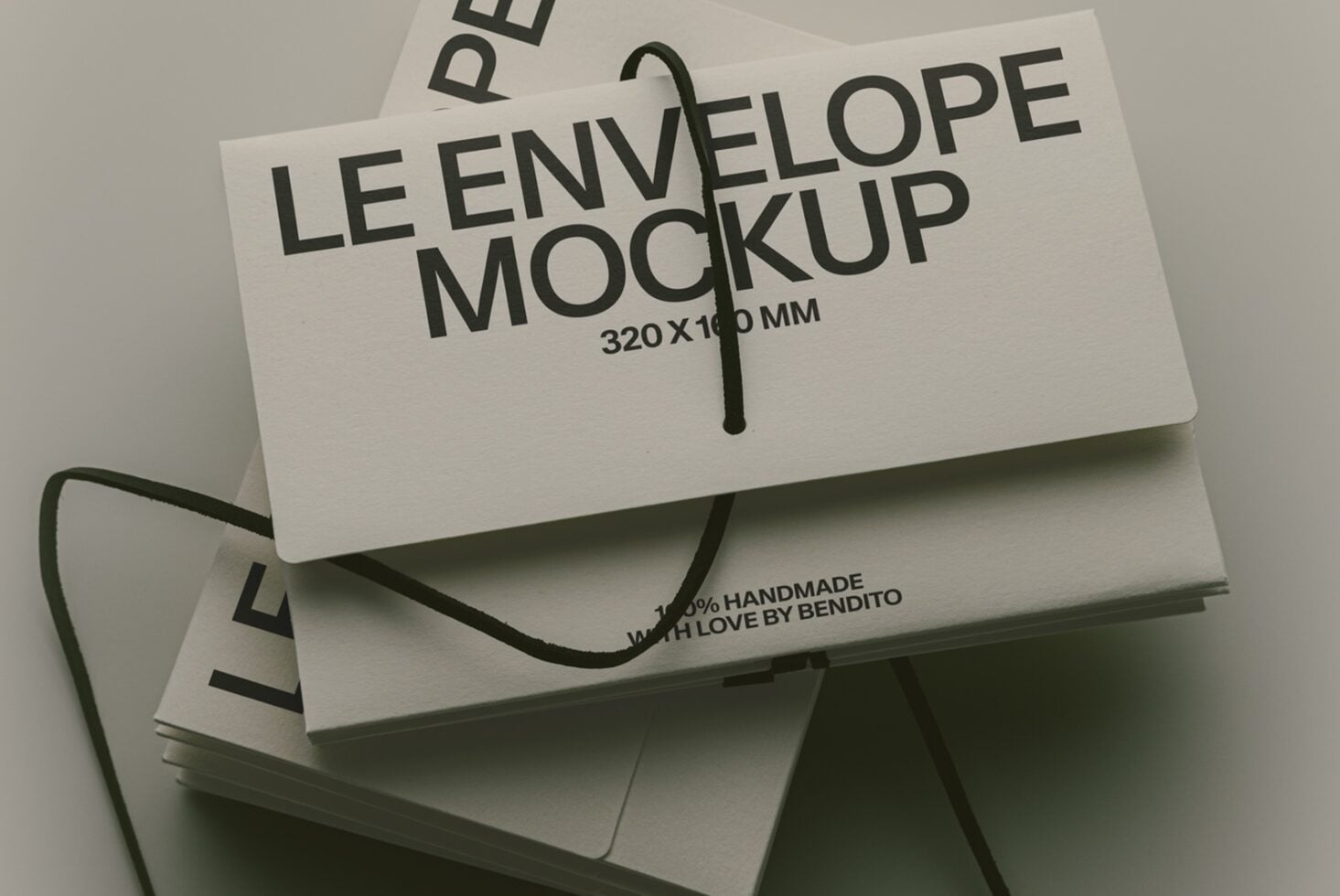 Stacked cream envelopes with black rope handles showing "Le Envelope Mockup" text overlay