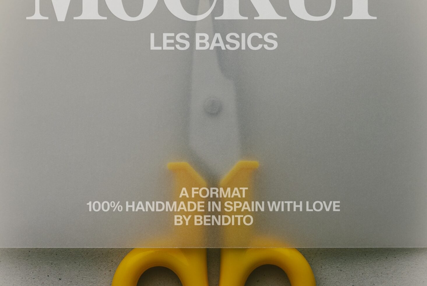 Bright yellow scissors cutting through design mockup with "Les Basics" typography overlaid on neutral background
