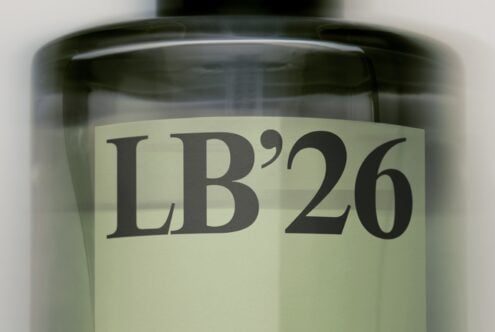 Closeup of dark glass jar with cream label showing serif typography reading LB26