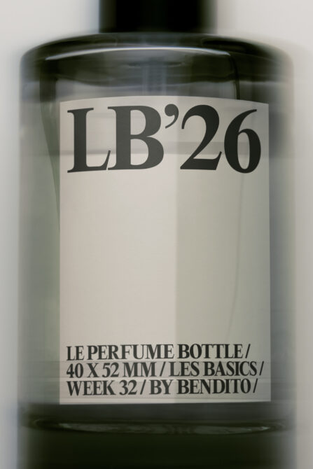 Minimalist perfume bottle mockup with cream label showing LB'26 branding in serif type