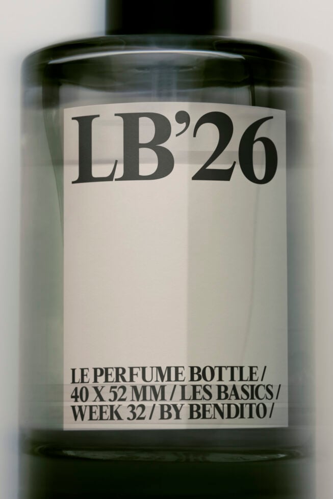 Minimalist perfume bottle mockup with cream label showing LB'26 branding in serif type