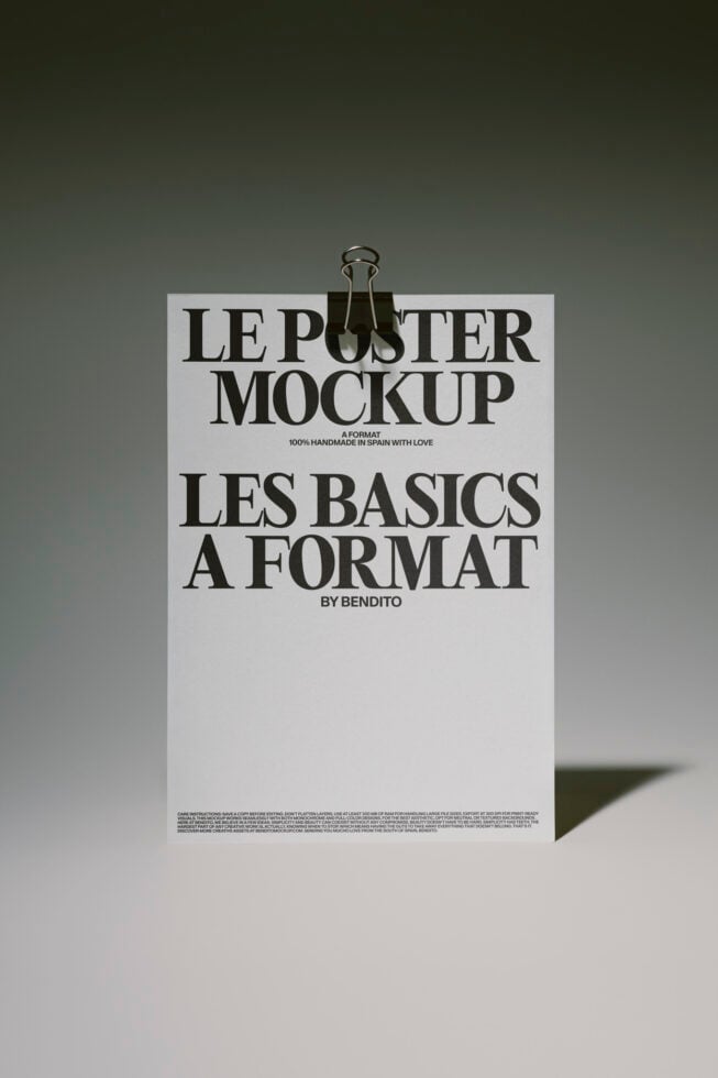 Minimalist poster mockup with binder clip, serif typography on cream paper, olive background with shadow