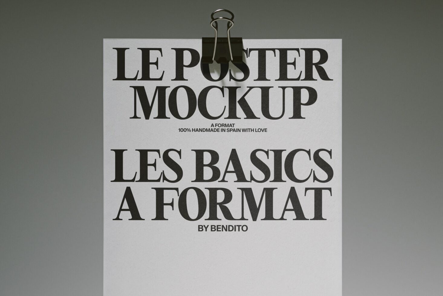 Cream poster with bold serif typography held up by a bottle clamp against olive background