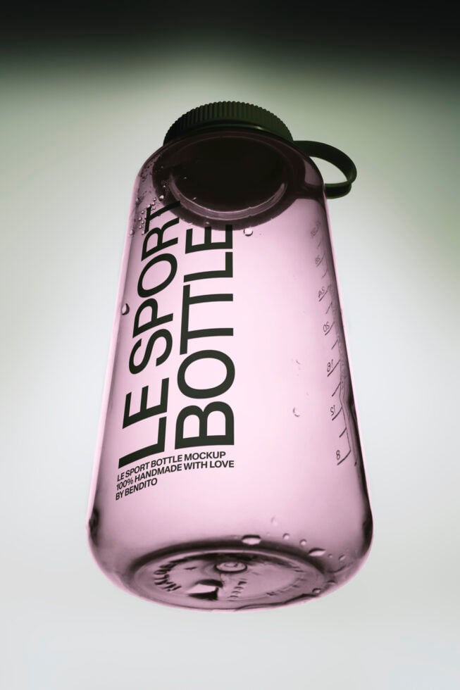 Pink sport bottle mockup with black cap, measurement markings, water droplets, showing bold typography layout