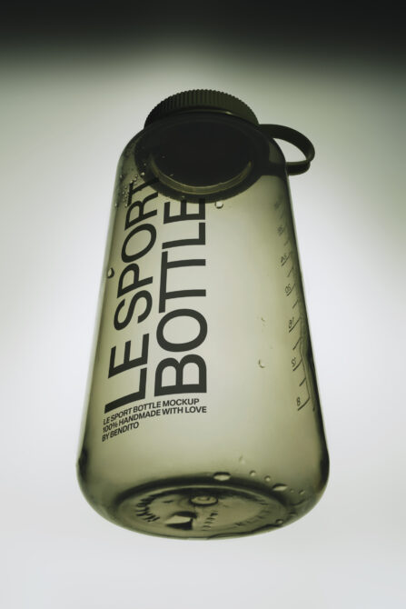 Translucent sport bottle mockup with black screw cap, measurement markings, water droplets on frosted green plastic