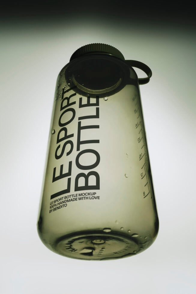 Translucent sport bottle mockup with black screw cap, measurement markings, water droplets on frosted green plastic