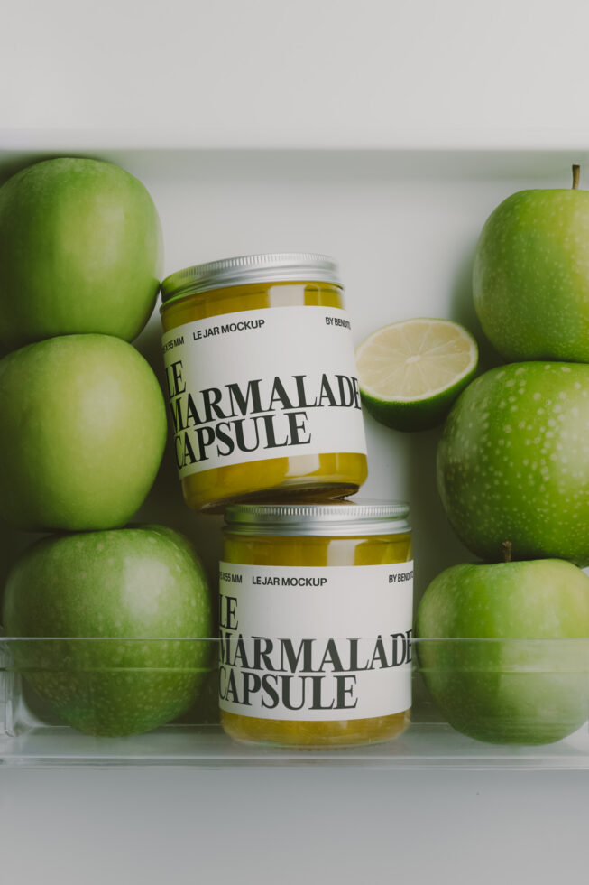 Two jam jars surrounded by fresh green apples with a sliced lime, clean product shot mockup