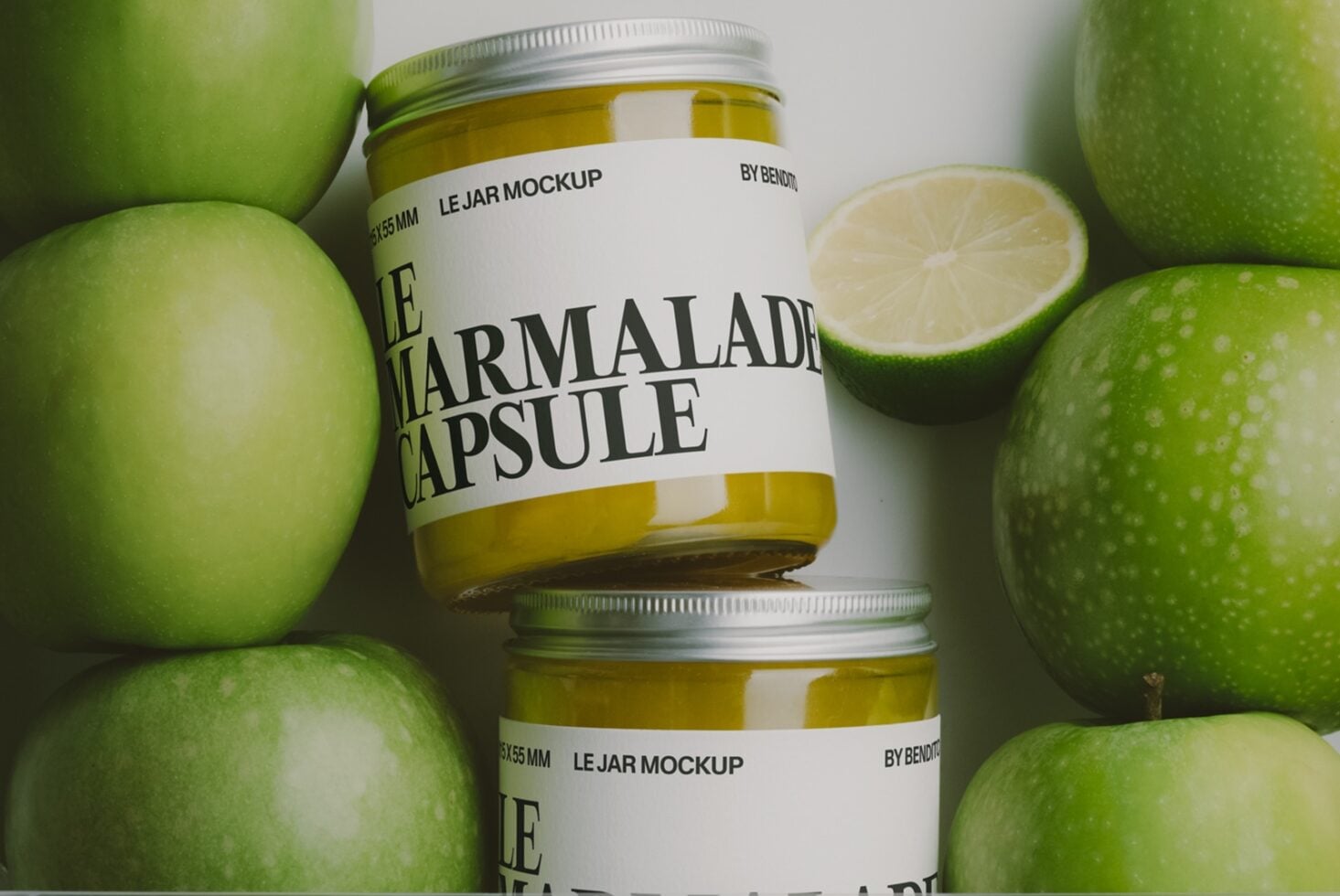 Jam jar mockup surrounded by fresh green apples with lemon slice styling