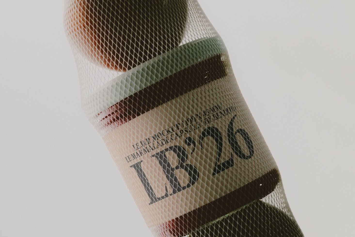 Mesh-wrapped wine bottle with layered color bands showing through textured netting material