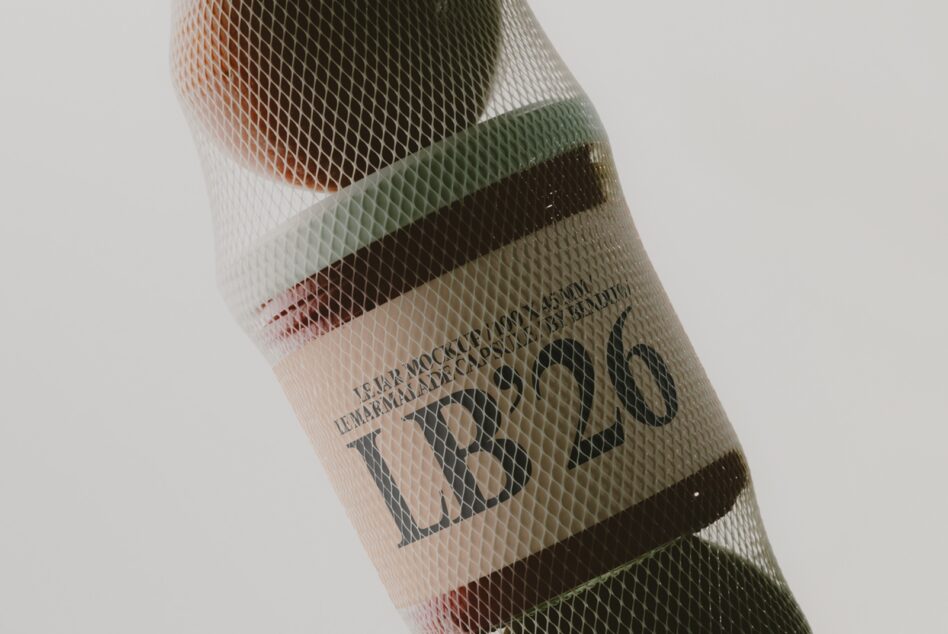 Mesh-wrapped wine bottle with layered color bands showing through textured netting material