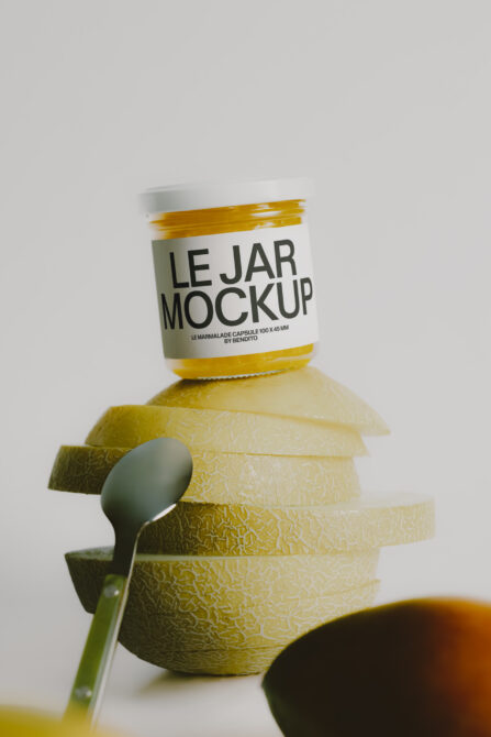 Jam jar mockup with white label stacked on sliced lemons, spoon on the side